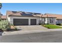 Charming home featuring a two-car garage, tile roof, solar panels, and well-manicured lawn at 9612 Glengarry Dr, Las Vegas, NV 89129
