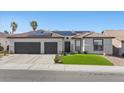 Charming home featuring a two-car garage, tile roof, solar panels, and well-manicured lawn at 9612 Glengarry Dr, Las Vegas, NV 89129