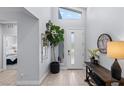 Bright entryway featuring wood-look tile floors, a high ceiling, and stylish decor touches at 9785 Granite Mesa St, Las Vegas, NV 89141