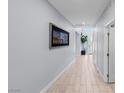 Hallway with tile floors, skylight, and a decorative picture on the wall at 9785 Granite Mesa St, Las Vegas, NV 89141