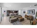 Open-concept living room with a large sofa, recessed lighting, and access to the patio at 9785 Granite Mesa St, Las Vegas, NV 89141