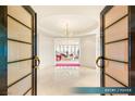 Elegant entry foyer with marble floors, chandelier, and an inviting view to the living area at 1 Hughes Center Dr # 903, Las Vegas, NV 89169