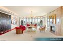 Bright living room with a fireplace, chandelier, floor to ceiling windows and city views at 1 Hughes Center Dr # 903, Las Vegas, NV 89169