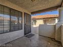 View of outdoor entry featuring iron security door and view of terracotta rooftops at 1409 Santa Margarita St # G, Las Vegas, NV 89146