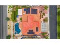 Aerial view of home showcasing a pool, patio, solar panels, and the unique roof design at 2010 Catalina Marie Ave, Henderson, NV 89074
