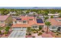 Beautiful two-story home with a red tile roof, solar panels, and a well-maintained landscape at 2010 Catalina Marie Ave, Henderson, NV 89074