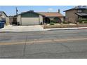 Charming single-story home featuring an attached garage, well-maintained landscaping, and a welcoming front porch at 308 Sunbeam Dr, Las Vegas, NV 89107