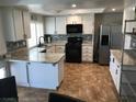 Modern kitchen with granite countertops, sleek cabinetry, and stainless steel appliances offers a stylish cooking space at 308 Sunbeam Dr, Las Vegas, NV 89107