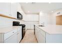 Modern kitchen features white cabinets, stainless steel appliances, and a large center island at 3240 Avernus Ave, Henderson, NV 89044