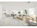 Spacious open-plan living area with modern decor, natural light, and stylish furnishings at 3240 Avernus Ave, Henderson, NV 89044
