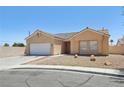 Charming front exterior with stucco facade, tiled roof, low maintenance desert landscaping, and attached two-car garage at 3538 Canter Dr, North Las Vegas, NV 89032
