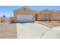 Single-level home featuring a neutral color scheme, tiled roof, desert landscaping, and an attached two-car garage at 3538 Canter Dr, North Las Vegas, NV 89032