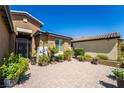 Charming courtyard with desert landscaping, brick pavers, and wrought-iron gate at 357 S Milan St, Henderson, NV 89015