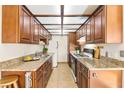 Efficient galley kitchen features ample cabinetry, granite countertops, and modern appliances at 3668 Villa Knolls East Dr, Las Vegas, NV 89120