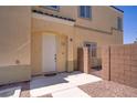 Home featuring a white front door with a small gravel entryway and a light tan stucco exterior at 4020 Smokey Fog Ave # 102, North Las Vegas, NV 89081