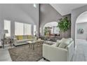 Spacious living room with soaring ceilings, bright windows, and stylish neutral decor at 4435 Peaceful Harbor St, Las Vegas, NV 89129
