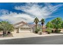 Single-story home with a well-maintained lawn, desert landscaping, and an attached three-car garage at 4612 Standing Bluff Way, Las Vegas, NV 89130