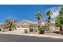 Single-story home featuring a tile roof, desert landscaping, and an attached three-car garage at 4612 Standing Bluff Way, Las Vegas, NV 89130
