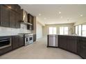 Modern kitchen boasts stainless steel appliances and connects to the dining area at 4630 Blushing Dawn Ave, Las Vegas, NV 89118