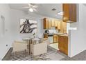 Cozy dining area with modern table and chairs, alongside a well-equipped kitchen with bright cabinets at 4730 E Craig Rd # 1093, Las Vegas, NV 89115