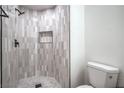 Bathroom featuring a tiled shower with a built-in niche and modern fixtures at 5321 Marietta Ave, Las Vegas, NV 89108