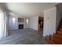 Open concept living room with wood floors and a fireplace at 5461 Dungaree St, Las Vegas, NV 89118