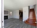 Open concept living room featuring new wood floors, fireplace and staircase access at 5461 Dungaree St, Las Vegas, NV 89118