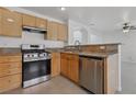 This kitchen features stainless steel appliances, granite counters, and wood cabinets at 575 Aspen Leaf St, Las Vegas, NV 89144