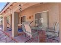 Cozy covered patio featuring a dining table set, chairs, and relaxing hammock at 5896 Shining Moon Ct, Las Vegas, NV 89131