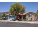 Charming single-story home with a well-manicured front yard and a delightful desert landscape at 5896 Shining Moon Ct, Las Vegas, NV 89131