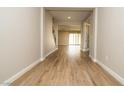 Hallway with wood-look tile flooring and open access to the living spaces of the home at 7199 Twilight Rider Ct, Las Vegas, NV 89118