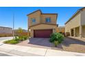 Two-story house with a two-car garage and a neatly paved driveway, embodying suburban living with its landscaped surroundings at 7730 Moore Creek Ln, North Las Vegas, NV 89084