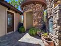 Stone turret entryway featuring a beautiful door and potted plants at 8010 Palm Cove Ct, Las Vegas, NV 89129