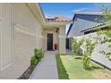 Inviting front entrance featuring a charming walkway, well-maintained landscaping, and a secure metal security gate at 814 Singing Drum Dr, Henderson, NV 89002