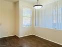 Bright dining room featuring wood floors and a contemporary light fixture at 908 Duckhorn Ct # 102, Las Vegas, NV 89144