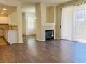 Inviting living room with modern fireplace, wood floors, and bright natural light at 908 Duckhorn Ct # 102, Las Vegas, NV 89144
