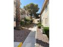 Exterior view of condo walkway with xeriscaping and desert landscaping at 925 Falconhead Ln # 102, Las Vegas, NV 89128