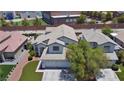Charming two-story home with a well-manicured lawn and a spacious two-car garage at 975 Leadville Meadows Dr, Henderson, NV 89052