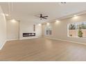 Bright and airy living room with hardwood floors, a modern fireplace, and recessed lighting at 9853 Russian Hill St, Las Vegas, NV 89141