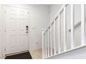 Bright entryway featuring a white staircase and neutral decor at 10013 Sable Point St, Las Vegas, NV 89178
