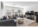 Cozy living room with plush sofas, natural light, and a contemporary entertainment center at 10013 Sable Point St, Las Vegas, NV 89178