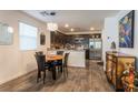 Open-concept kitchen featuring dark wood cabinetry, stainless steel appliances, and granite countertops at 12237 Plum Mist Ct # 4, Las Vegas, NV 89183
