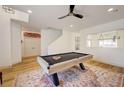 Bright game room with modern ceiling fan, a pool table, and wood-style flooring at 189 Andada Dr, Henderson, NV 89012