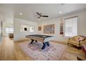 Bright game room with modern ceiling fan, a pool table, and wood-style flooring at 189 Andada Dr, Henderson, NV 89012