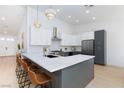 Stylish kitchen featuring white cabinets, stainless steel appliances, and a large marble island at 2475 Sedona Cedar Ave, Henderson, NV 89052