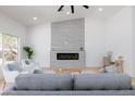 Cozy living room with a modern fireplace and seating area perfect for relaxation at 2475 Sedona Cedar Ave, Henderson, NV 89052