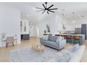 Bright living room features modern furnishings, stylish bar area, and seamless flow to kitchen at 2475 Sedona Cedar Ave, Henderson, NV 89052