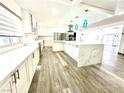 Large kitchen with stainless appliances, modern countertops, and island providing ample counter space at 2903 Hardin Dr, Henderson, NV 89074