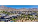 Expansive aerial view of houses with desert mountains in the distance at 312 Wind Poppy St, Las Vegas, NV 89138