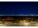 Distant city lights sparkle on the horizon at night at 312 Wind Poppy St, Las Vegas, NV 89138